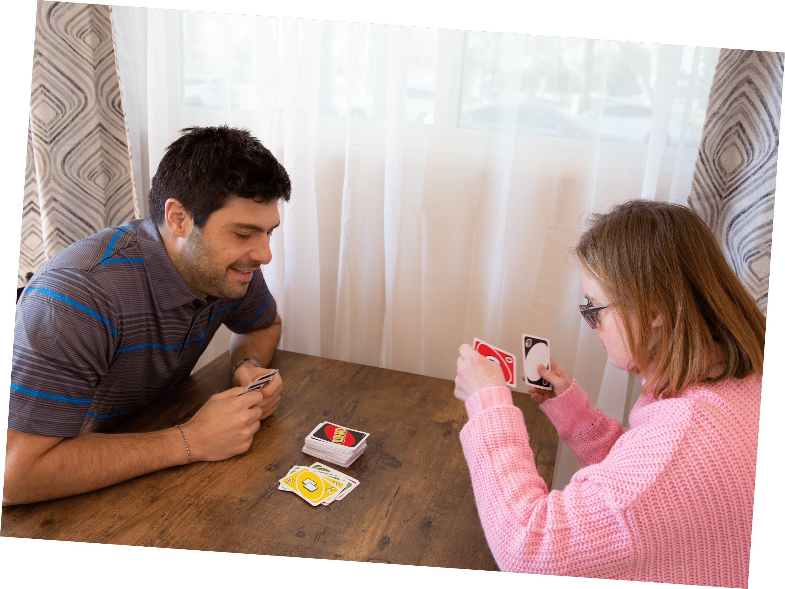 MDH staff member playing a card game with an individual