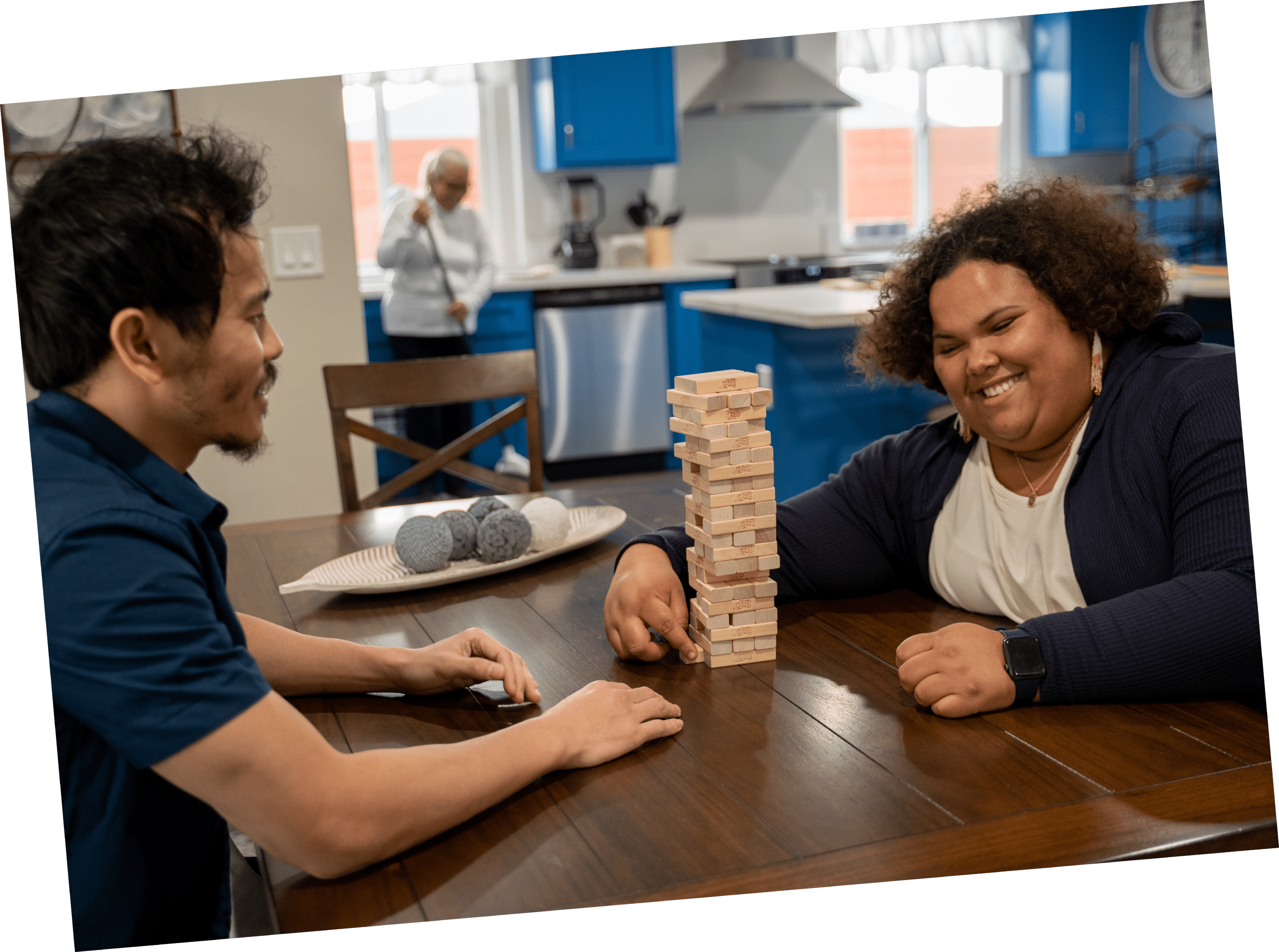 MDH staff member playing a tabletop game with an individual